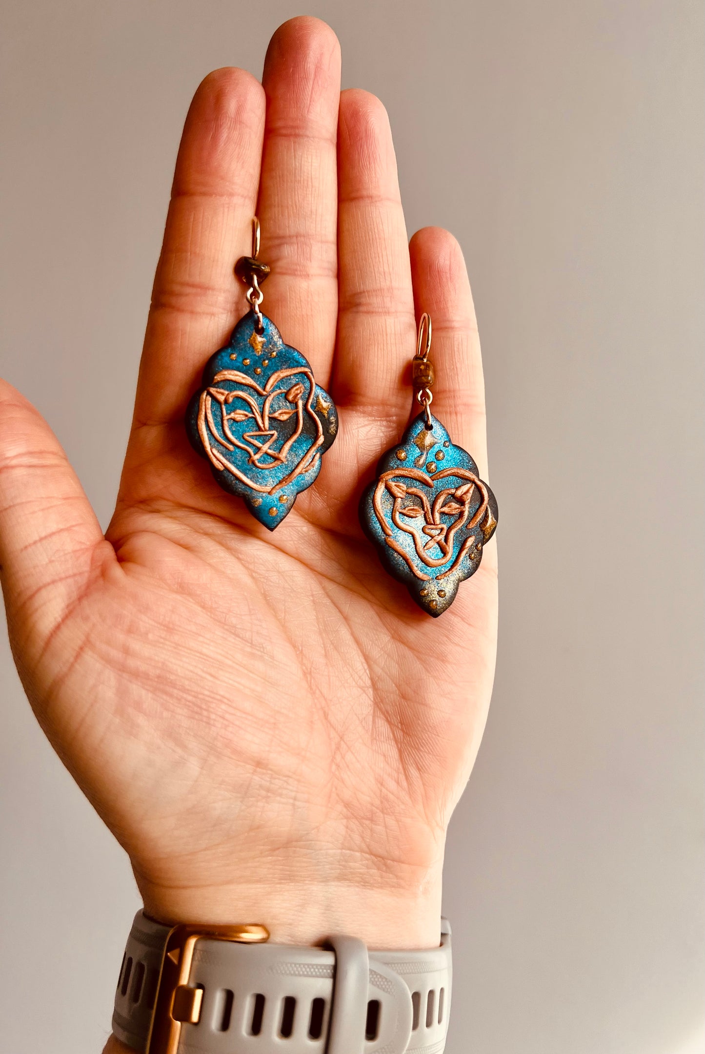 Stylish polymer clay Leo earrings featuring a captivating tiger eye stone. Handcrafted with care, these earrings embody the bold and confident nature of Leo, while the tiger eye stone enhances courage and strength. Show off your Leo pride with this stunning accessory. Shop now!