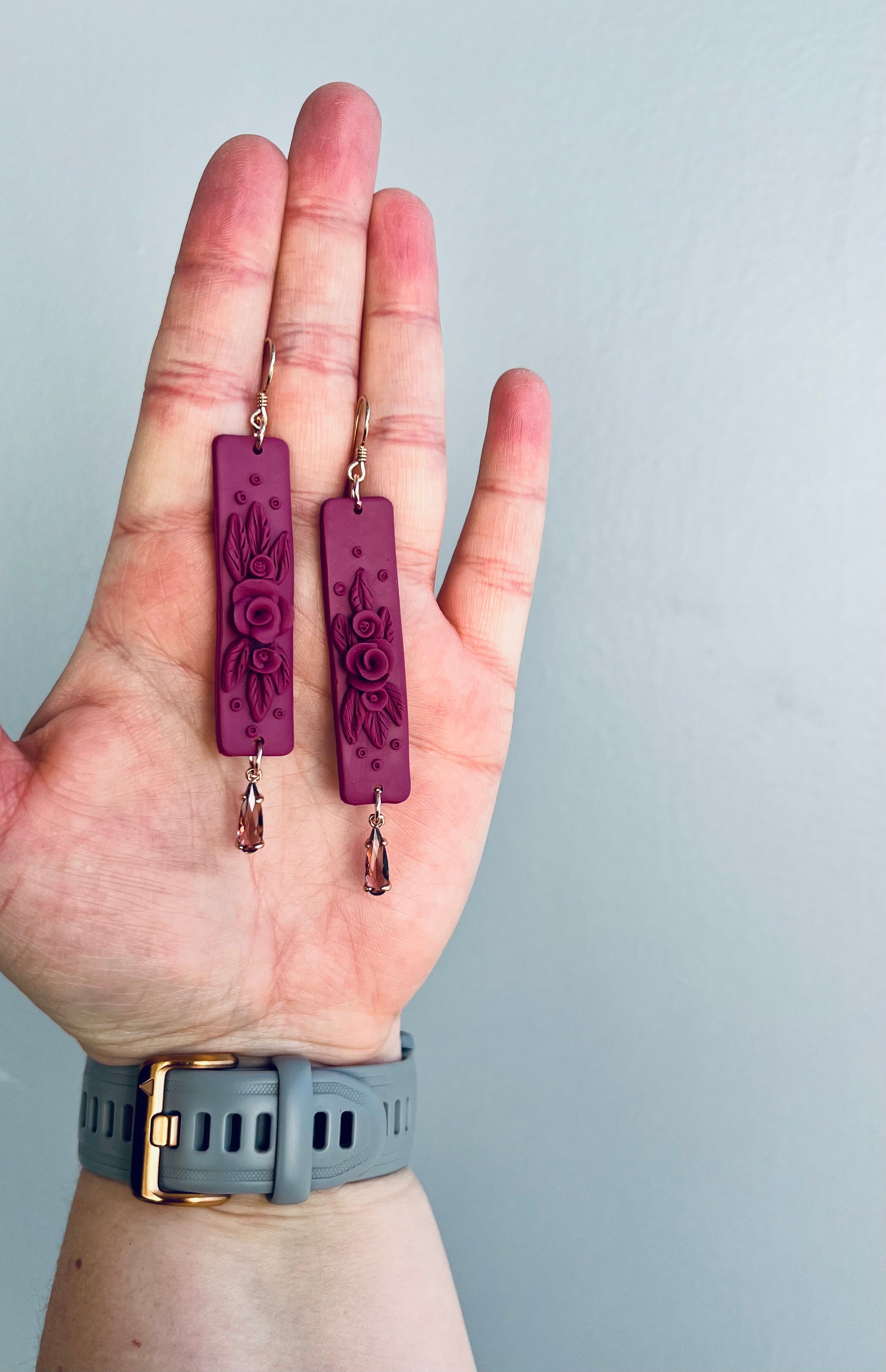 Complete your look with our exquisite mauve monochrome polymer clay earrings featuring intricate rose detailing. Radiating sophistication and grace, these earrings are a must-have addition to any jewelry collection. Embrace effortless elegance with these versatile statement pieces!