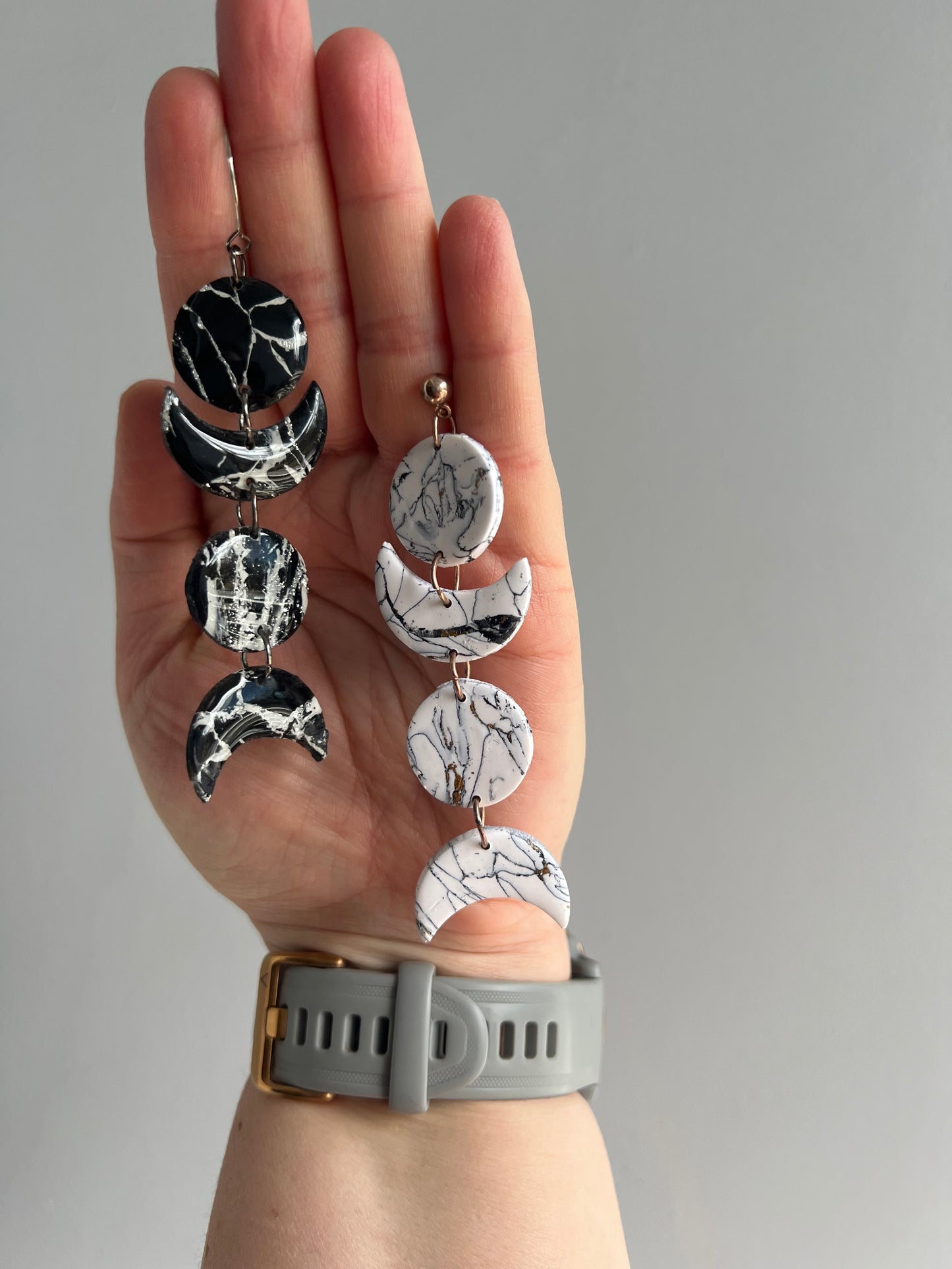 Illuminate your style with our polymer clay earrings, showcasing the enchanting contrast of black and white moon phases, perfect for moonlight revelers.