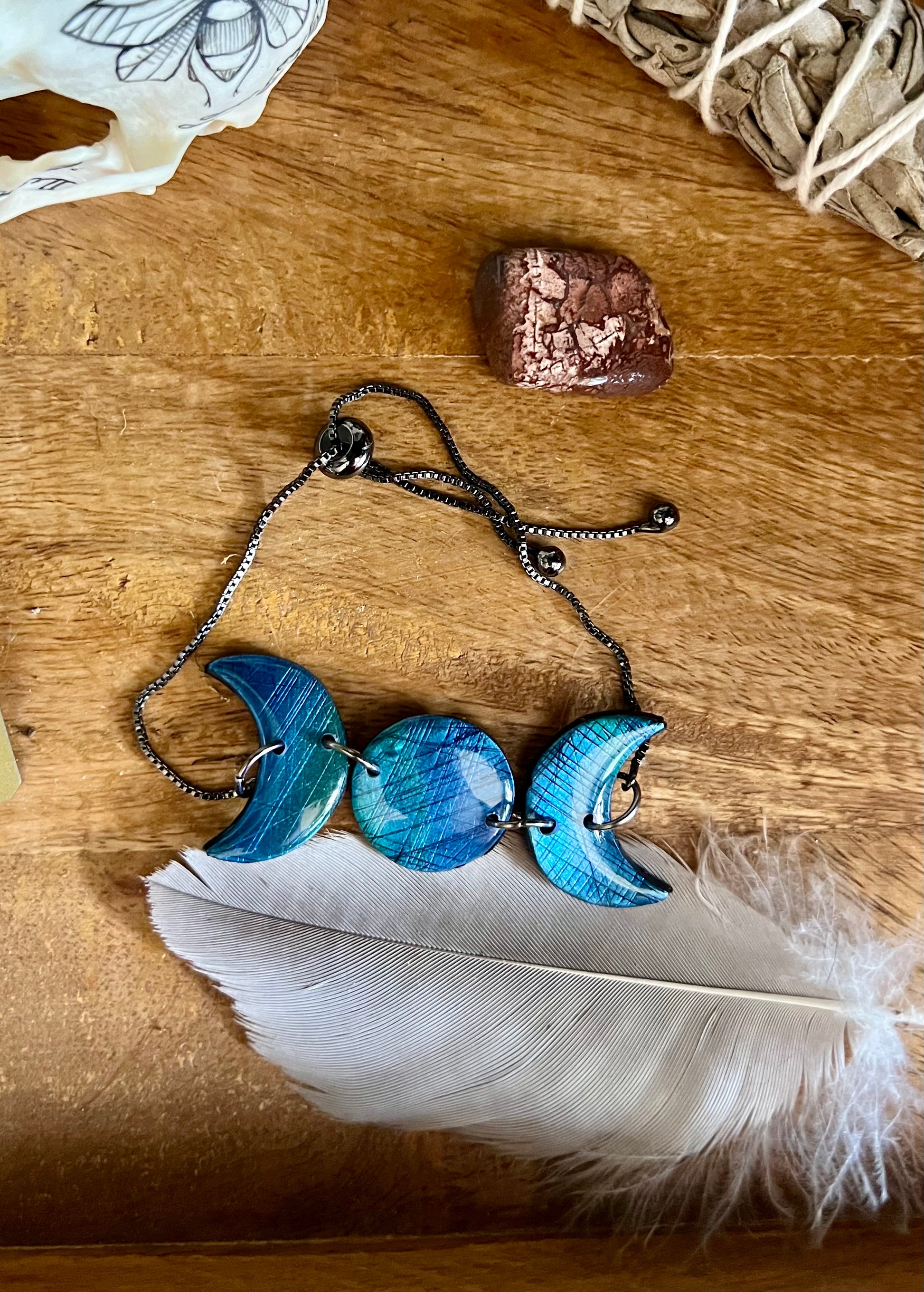 Illuminate your style with moon phase polymer clay bracelets, intricately designed with mica pigments to mimic the shimmering beauty of labradorite. Embrace the healing properties of labradorite as you adorn yourself with these captivating bracelets.