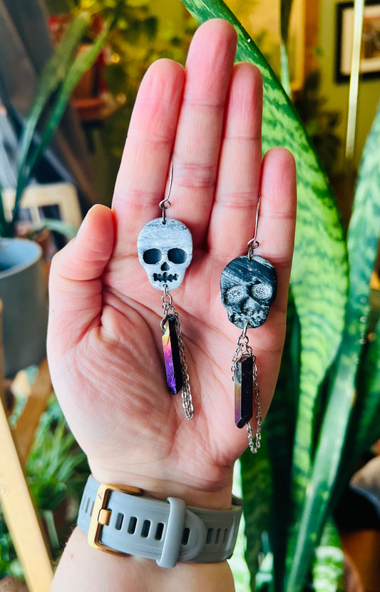Embrace the mystical charm of our marbled skull earrings, perfect for those drawn to the secrets of the unseen. They are adorned with a purple crystal to invoke a sense of wonder and enchantment.