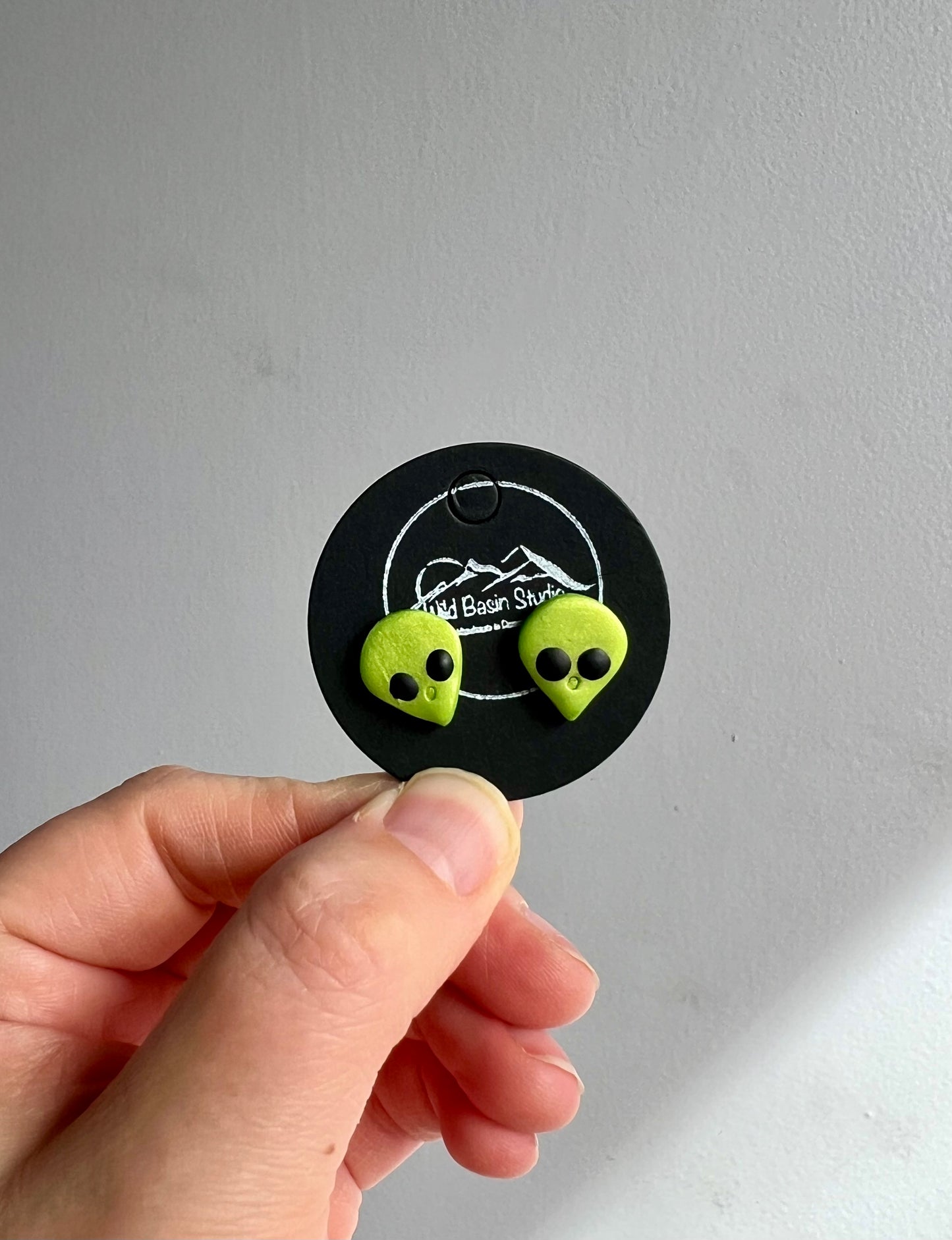 Capture the imagination with our green alien earrings, a quirky accessory sure to turn heads. These extraterrestrial-inspired earrings boast a playful design, perfect for adding a touch of cosmic charm to any outfit. Amplify your style with these unique statement pieces!