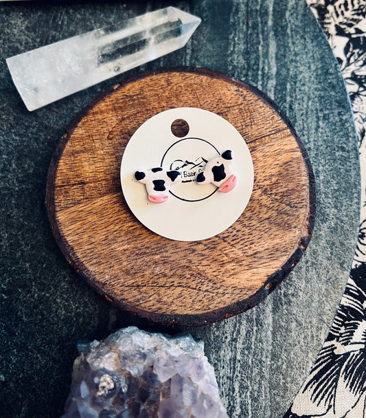 Enhance your western chic look with our farm-inspired cow stud earrings, meticulously handcrafted from polymer clay. These charming accessories add a touch of rustic charm to any outfit, perfect for country lovers and western enthusiasts. Available now!
