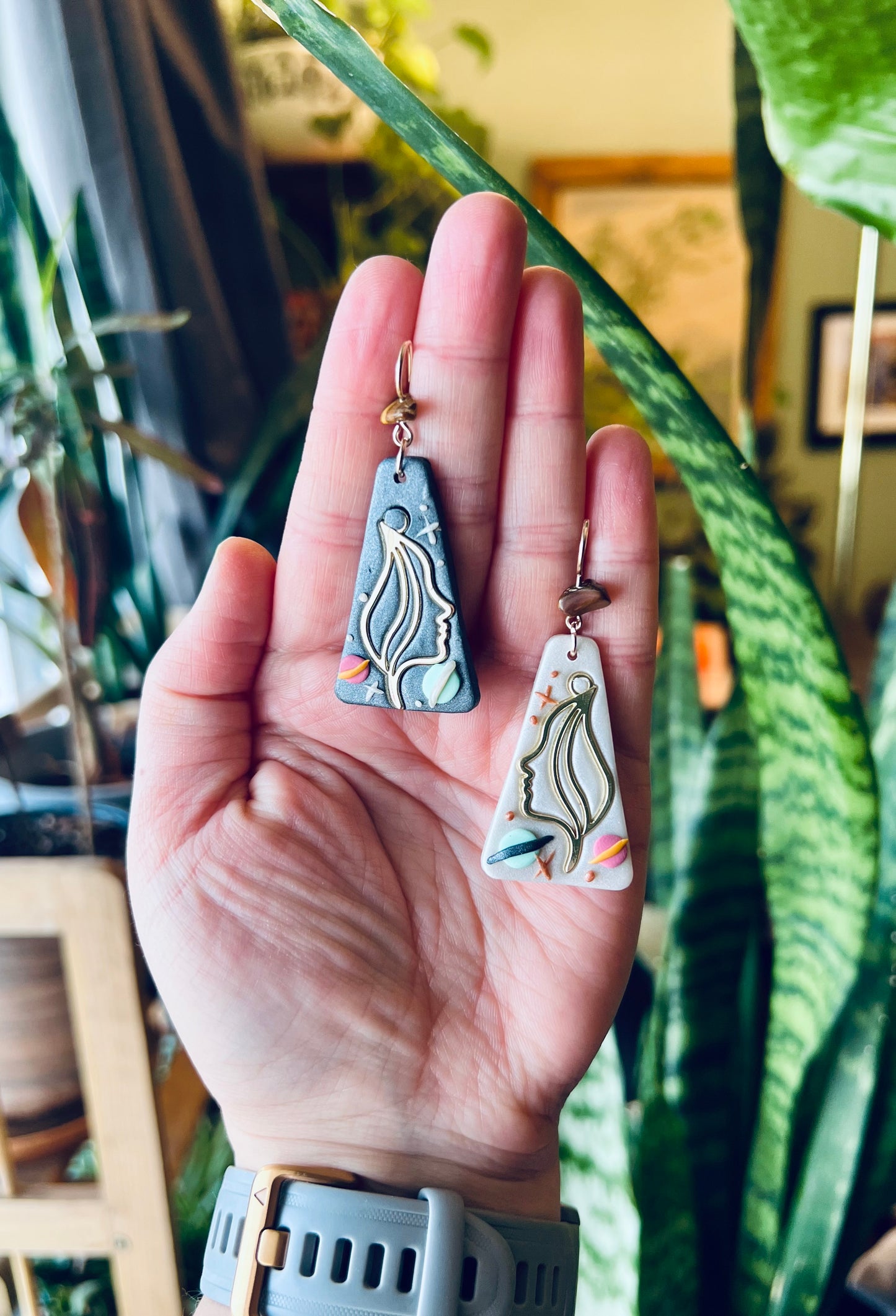 Dazzling Gemini earrings featuring celestial twins set against a backdrop of space. Symbolizing duality and curiosity, these earrings capture the essence of the Gemini sign. Shop now and embody the spirit of the Gemini twins!