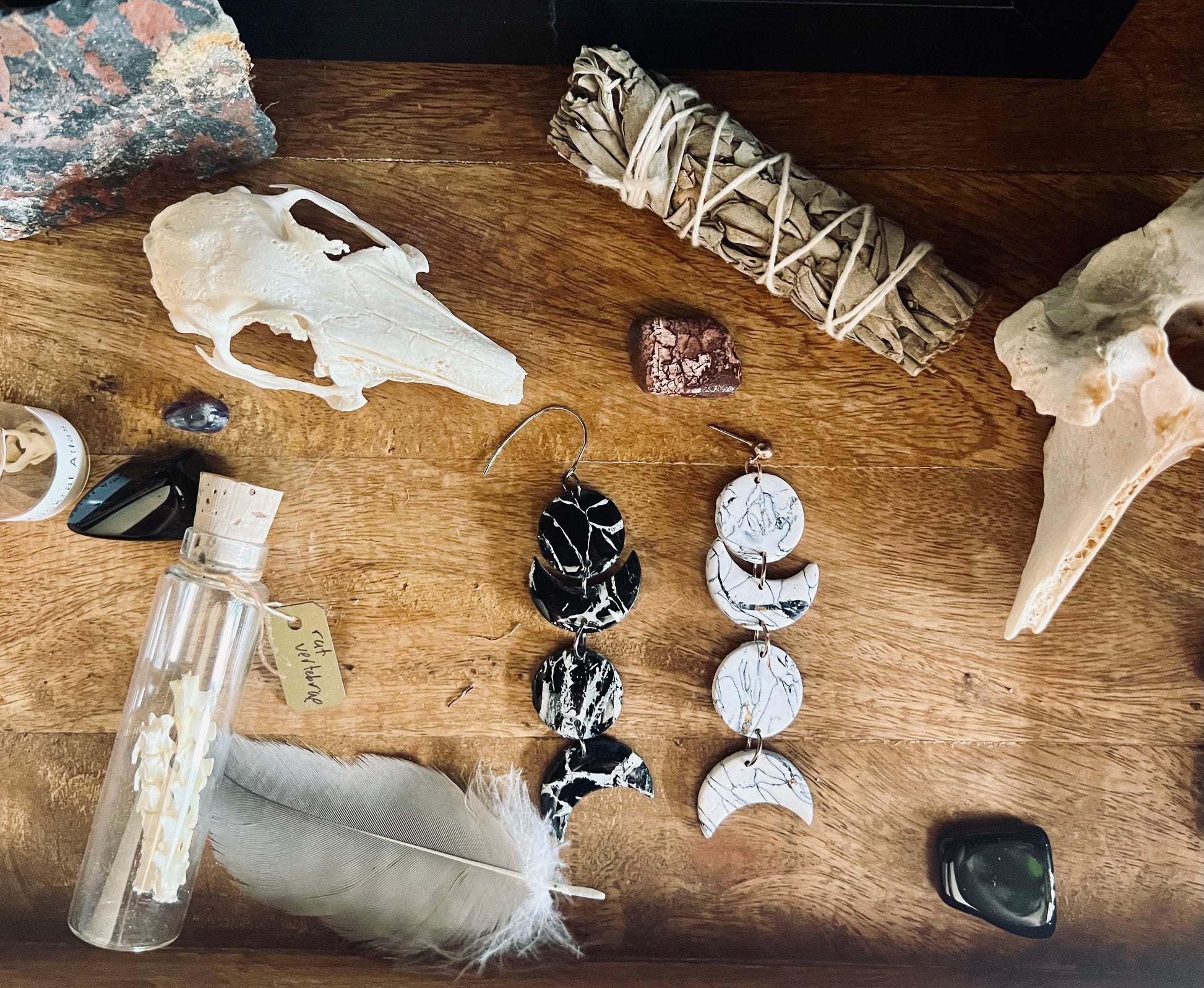 Add a touch of celestial charm to your ensemble with our handmade polymer clay earrings, featuring intricate black and white moon phases.