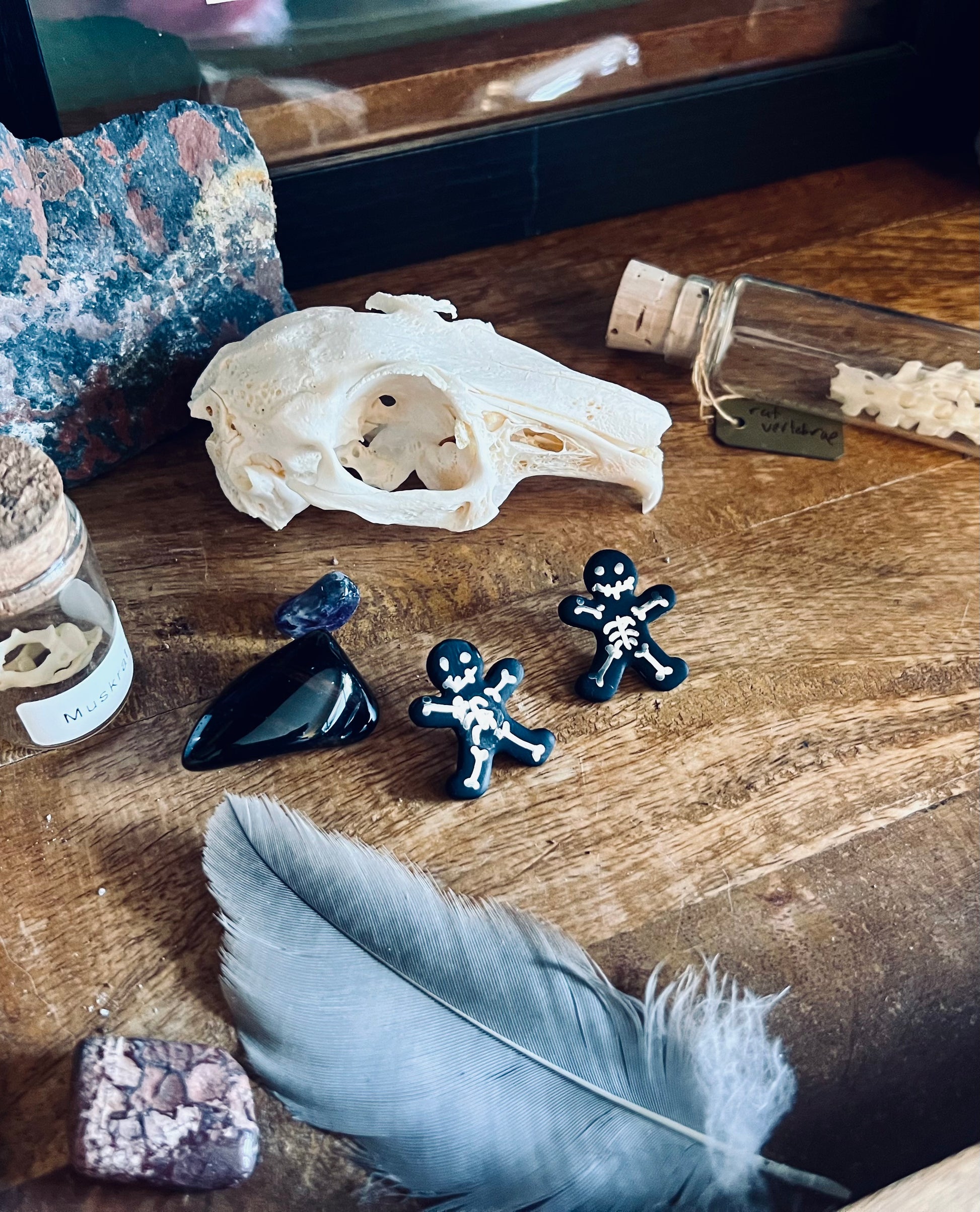 Explore the dark beauty of our black skeleton earrings, featuring silver bones for a striking contrast and gothic appeal.