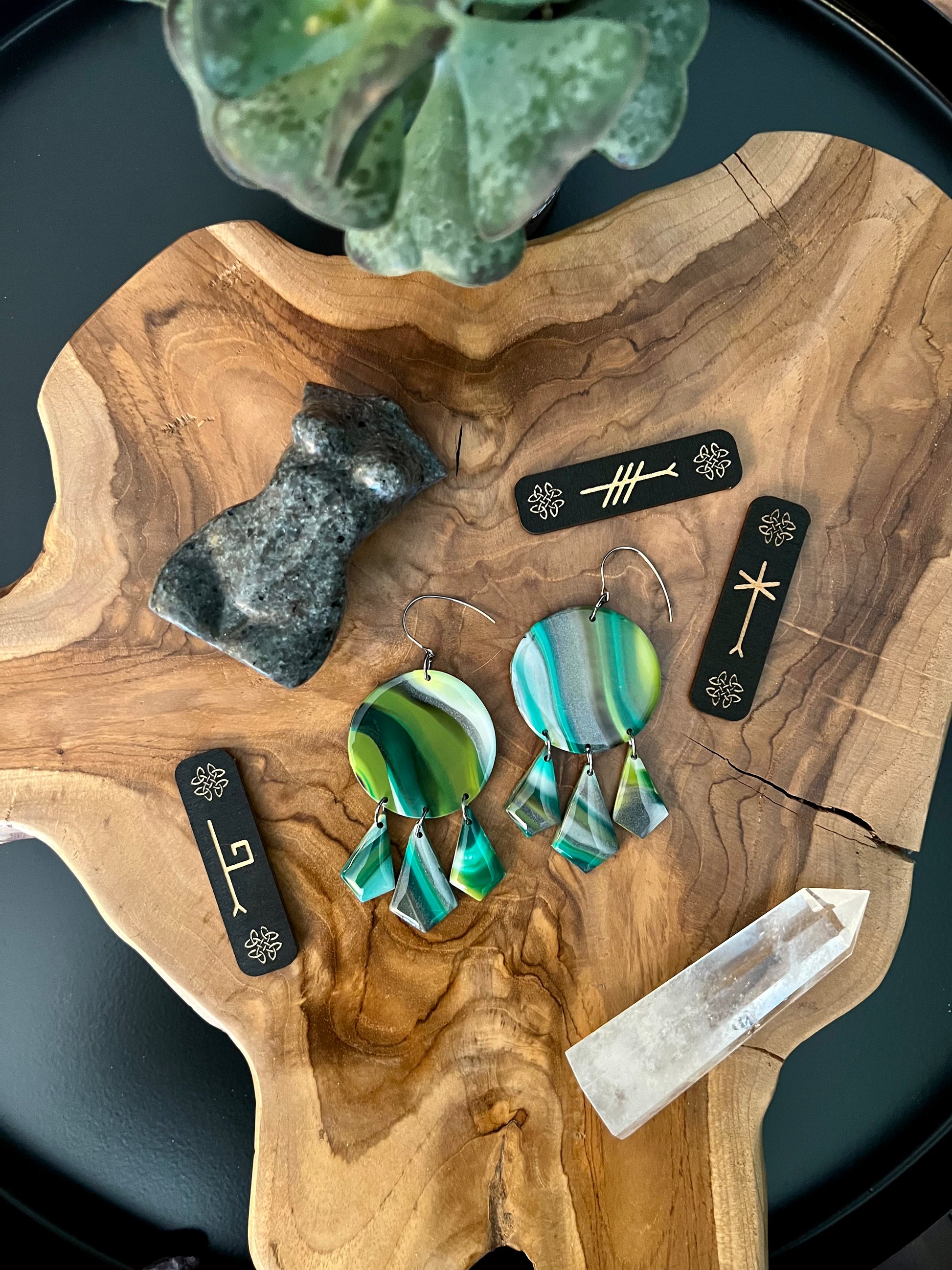 Unleash the power of nature with our polymer clay earrings, each uniquely handmade from shades of green, silver, and white. Symbolizing rebirth and renewal, these earrings bring the energy of the earth to the wearer, fostering growth and harmony.