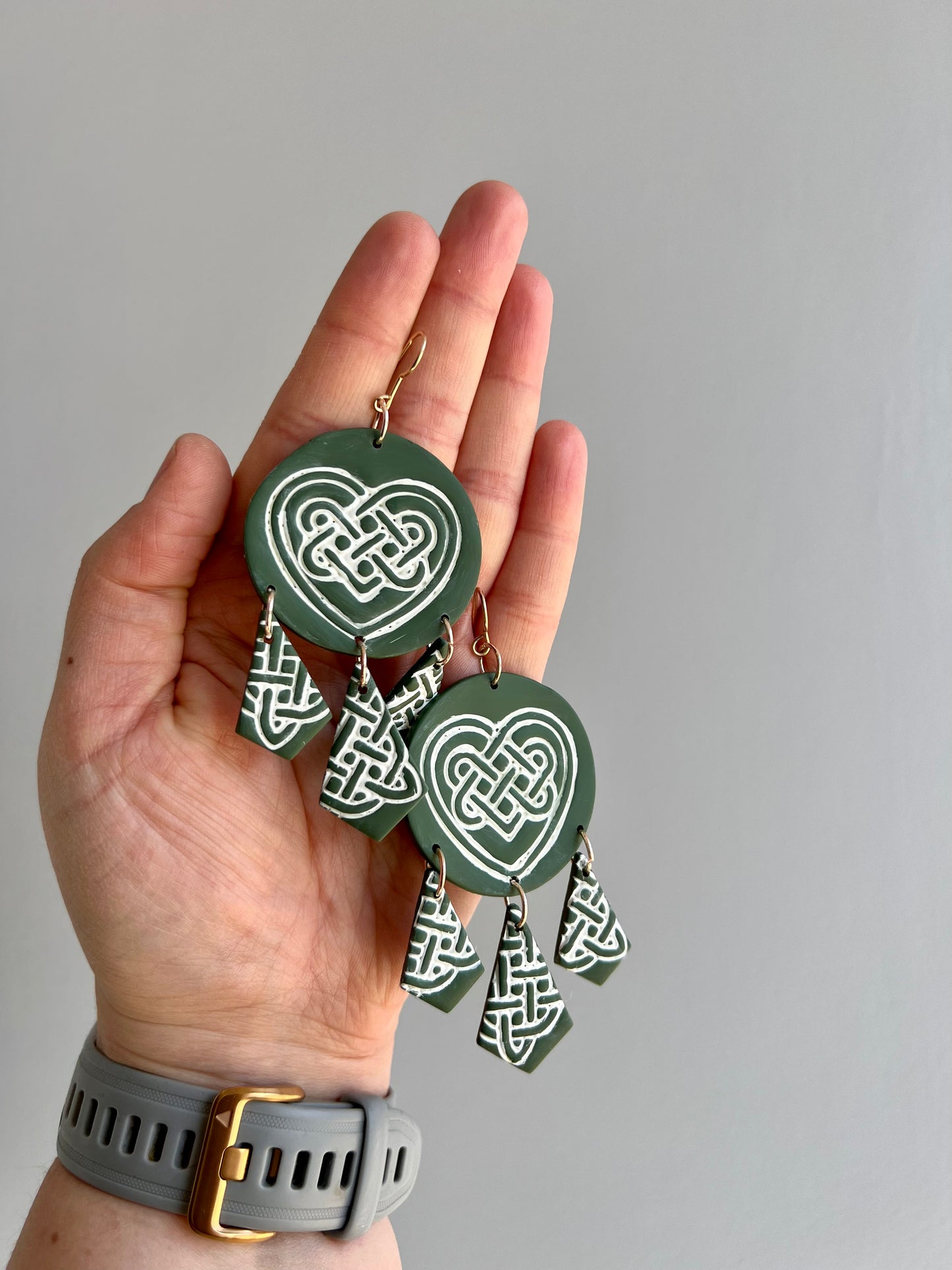 Unveil the allure of Celtic tradition with our green polymer clay earrings showcasing a delicate love knot design. These earrings symbolize eternal love and unity, adding a touch of romance to any outfit. Elevate your style with these beautifully crafted accessories, perfect for expressing your heartfelt sentiments.