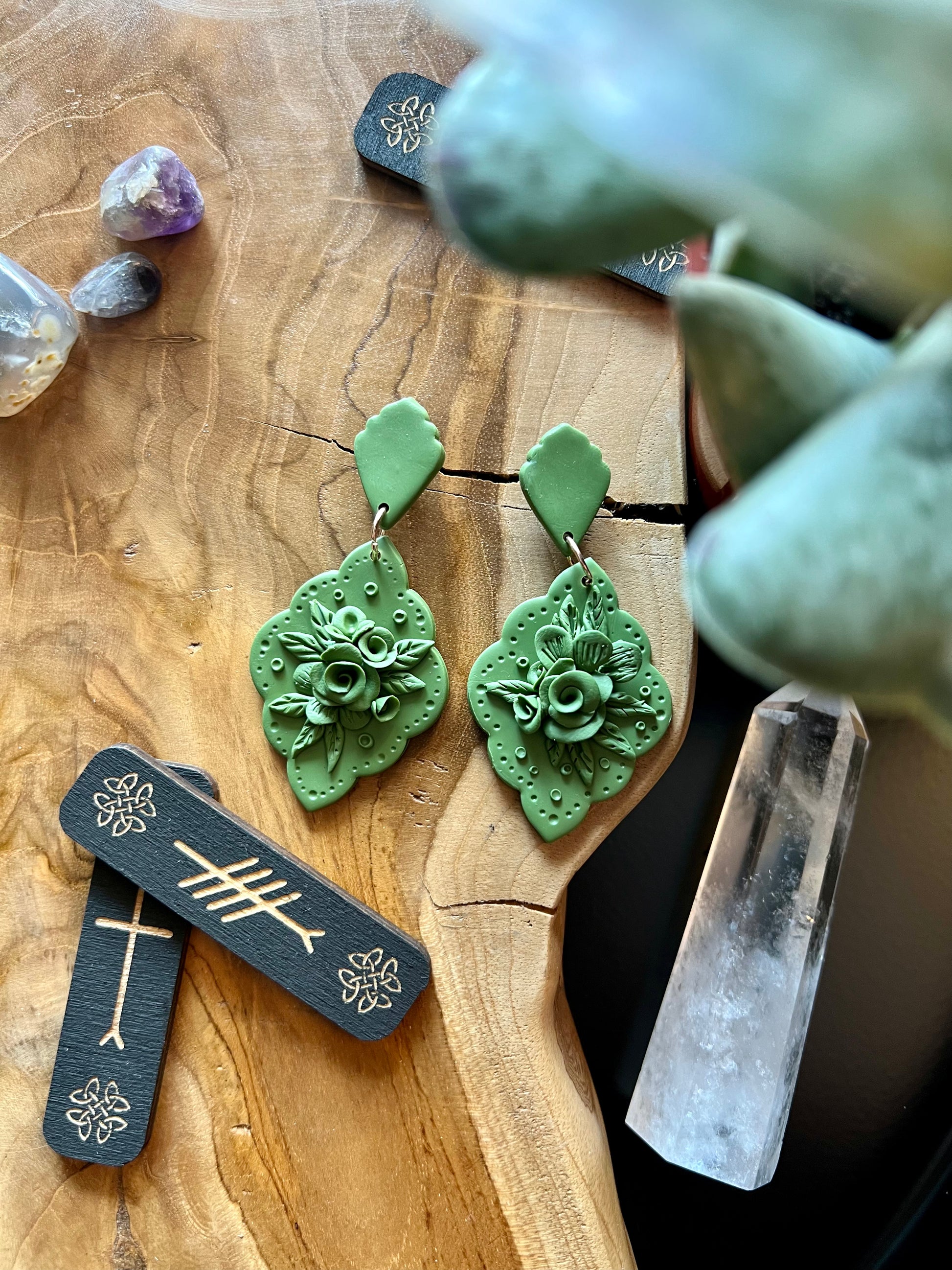 Elevate your style with our monochromatic olive floral earrings, inspired by the ancient symbol of peace, expertly crafted from polymer clay for a touch of artisanal elegance.