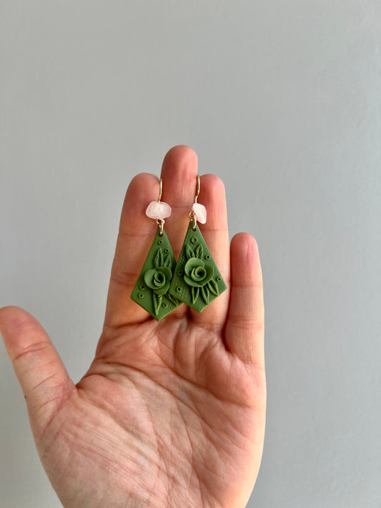 Embrace the harmonious energy of peace and friendship with our olive-colored earrings, adorned with handcrafted botanical accents and infused with the healing properties of rose quartz.