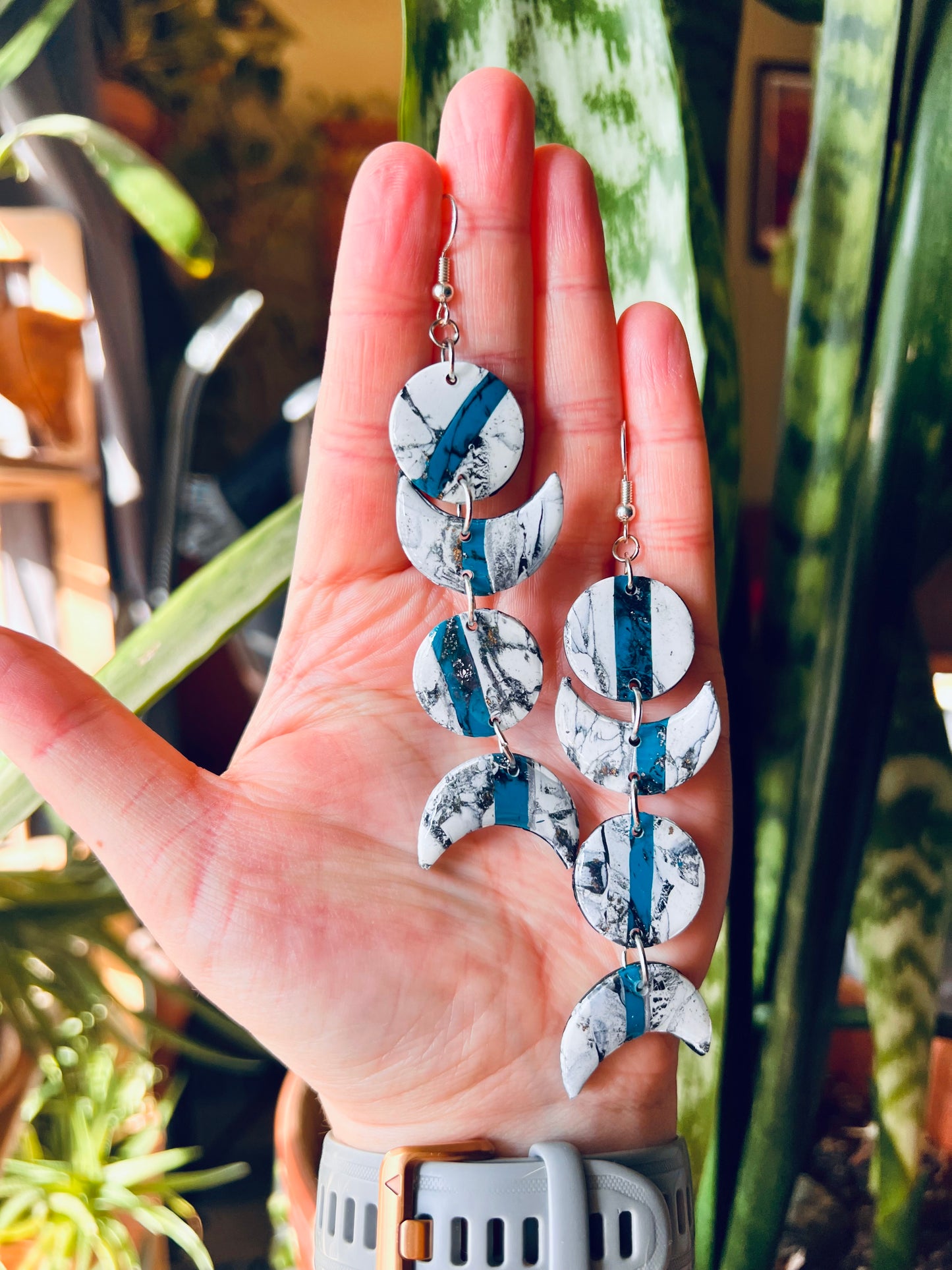 Capture the mystique of the Southwest with our moon phase-inspired polymer clay earrings, featuring faux marble and turquoise accents. Symbolizing the region's rugged beauty and connection to nature, these earrings evoke the enchanting allure of the desert moon. Elevate your style with a touch of southwestern charm and celestial elegance.