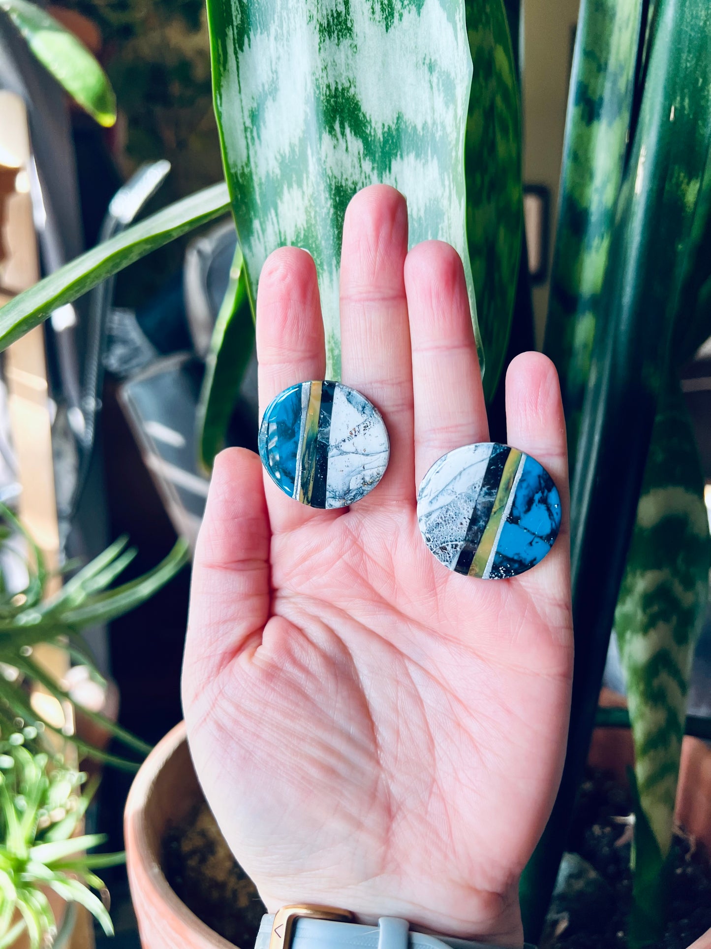 Round earring studs that are handcrafted from polymer clay. Featuring faux marble and turquoise designs, inspired by the rustic elegance of the Southwest. Channeling the region's symbolism of strength and connection to the earth.
