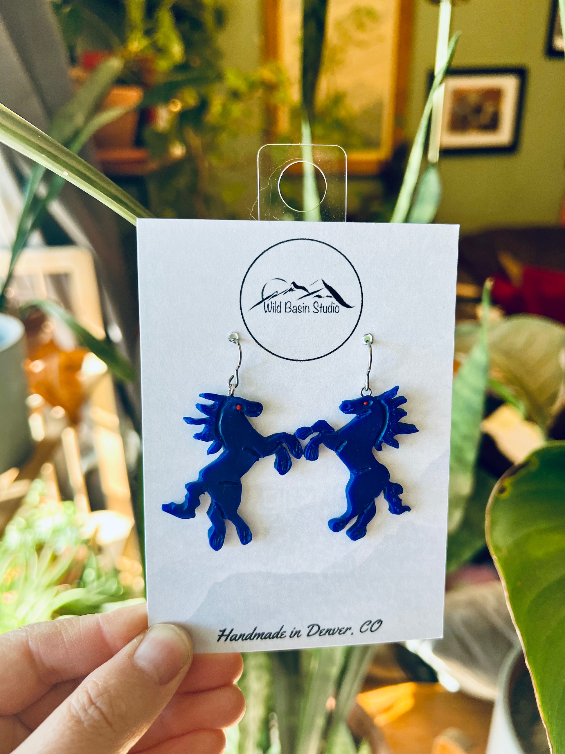 Experience the iconic Blucifer at DIA in a new way with our polymer clay earrings inspired by this Denver landmark. These artisan-crafted earrings capture the spirit of the Blue Mustang, adding a touch of local charm to your style. Show off your Mile High pride with these unique statement pieces!
