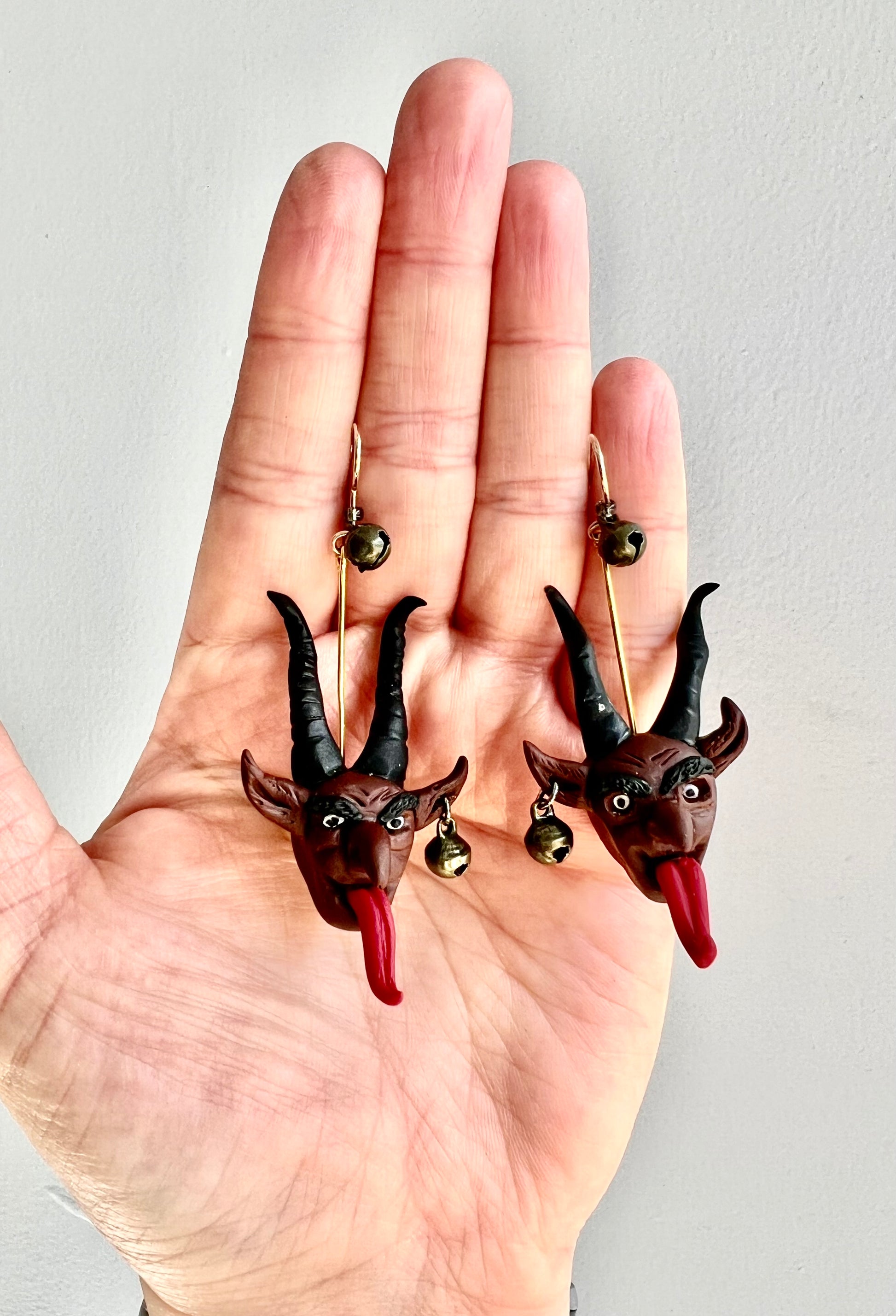 Capture the dark allure of folklore with our Krampus earrings, featuring hand-sculpted details and haunting bells reminiscent of sinister tales."