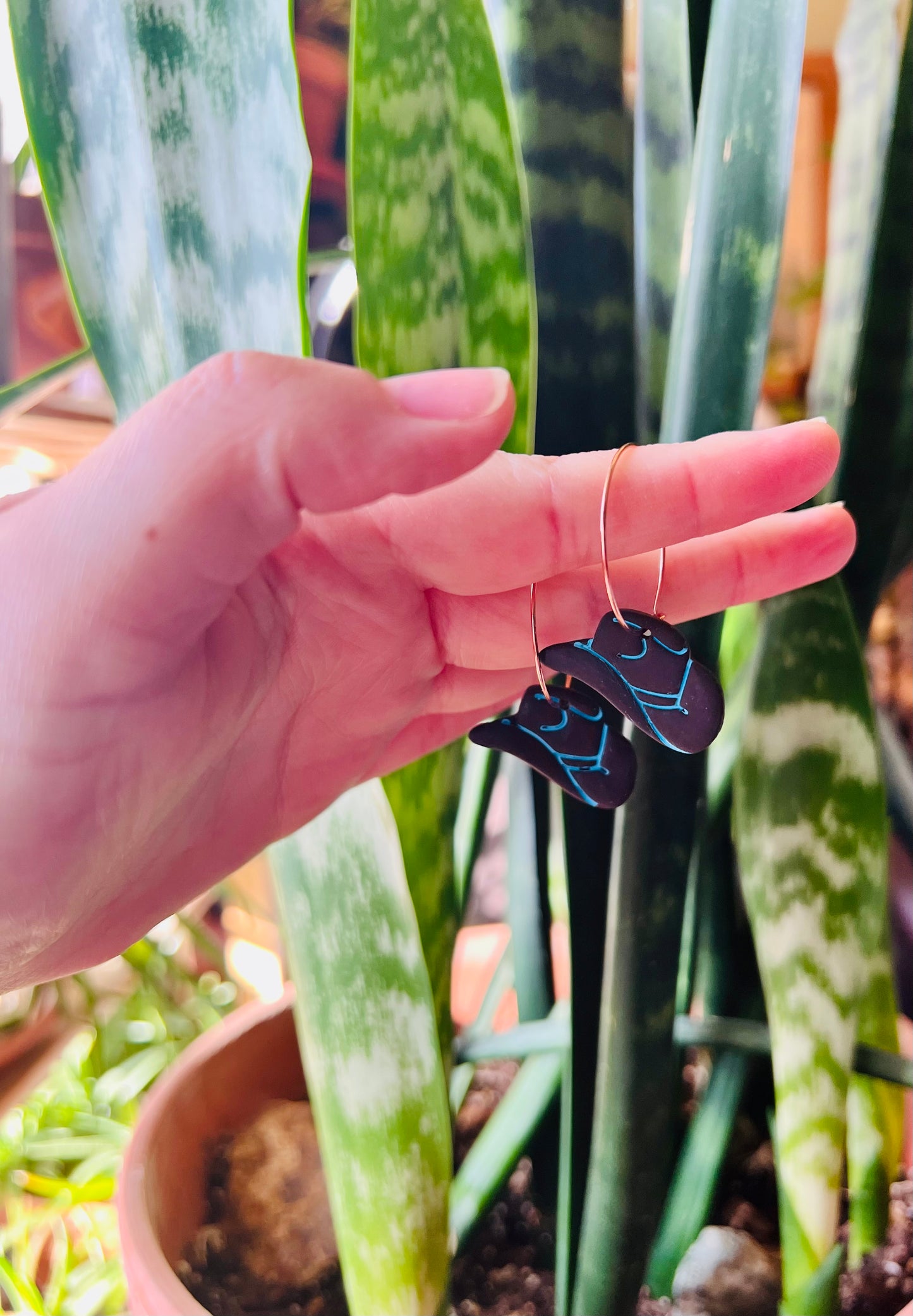 Complete your cowgirl look with our brown and blue cowgirl hat polymer clay earrings. These charming accessories add a touch of western flair to any ensemble, perfect for rodeos, line dancing, or casual outings. Handcrafted with care for a unique statement piece.