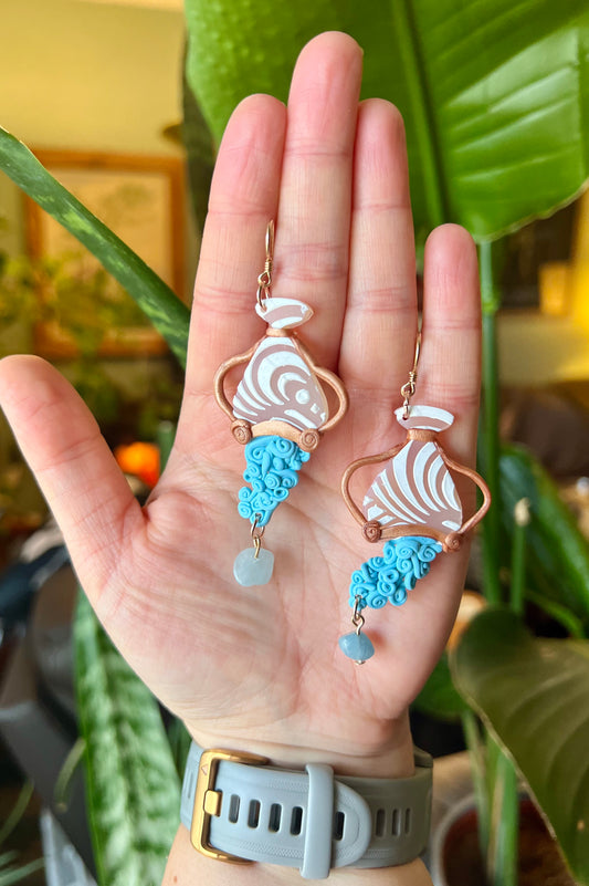 Beautiful polymer clay Aquarius earrings adorned with genuine aquamarine gemstones. Handcrafted with care, these earrings capture the innovative and free-spirited essence of Aquarius while harnessing the soothing energy of aquamarine. Elevate your style and embrace your Aquarian identity with these artisanal accessories. Shop now!
