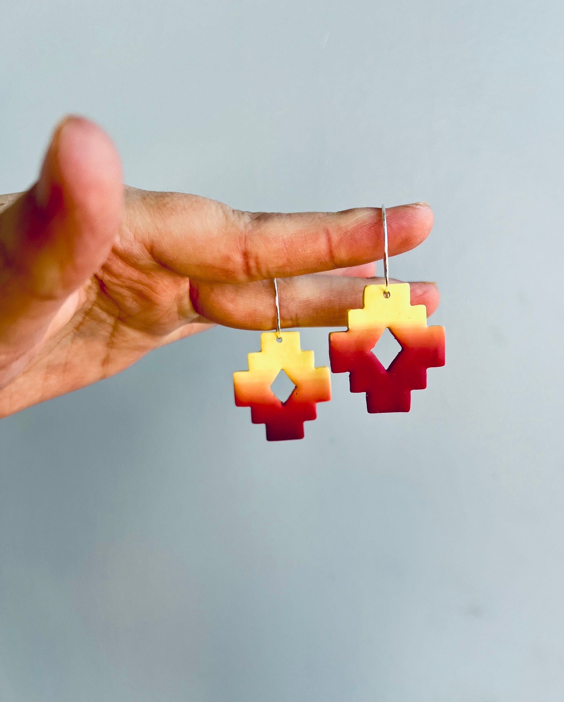 Capture the essence of the Southwest with our stunning polymer clay earrings, featuring crimson and golden yellow hues reminiscent of the desert sun. Perfect for adding a touch of desert-inspired elegance to any ensemble.