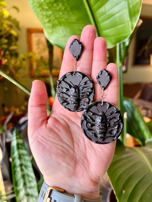 Capture the mystique of the brown death moth with our intricately crafted earrings. Symbolizing transformation and the fleeting nature of life, these Gothic-inspired accessories add a touch of elegance to any ensemble.