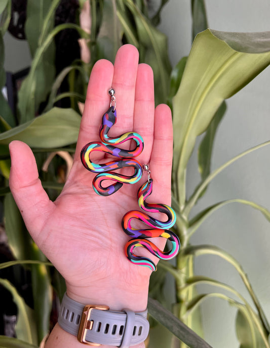 Get a flashback to the vibrant 1980s with these funky, colorful snake earrings! Perfect for adding a retro twist to your style. Shop now for a bold statement piece that's totally rad!