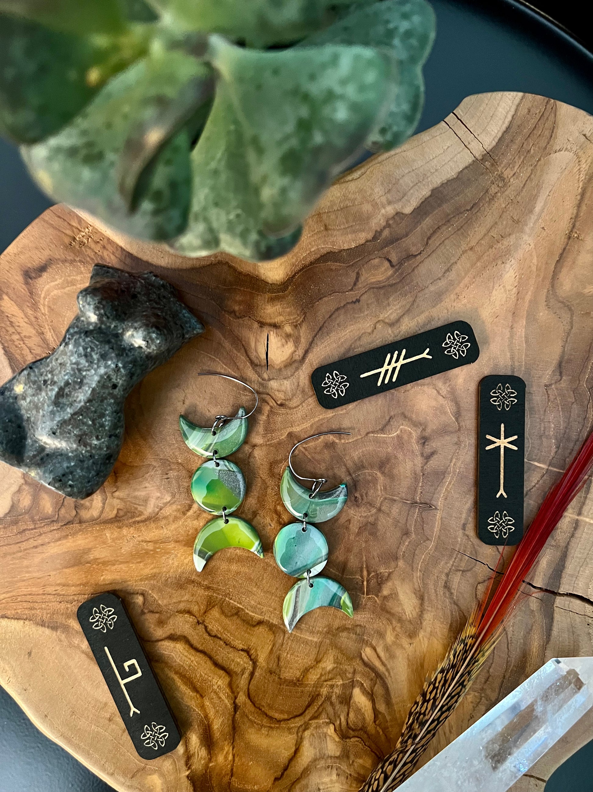 Elevate your style with our handmade polymer clay earrings, crafted from various shades of green, silver, and white. Symbolizing renewal and balance, these earrings embody the energy of the earth, offering a unique expression of nature's beauty.