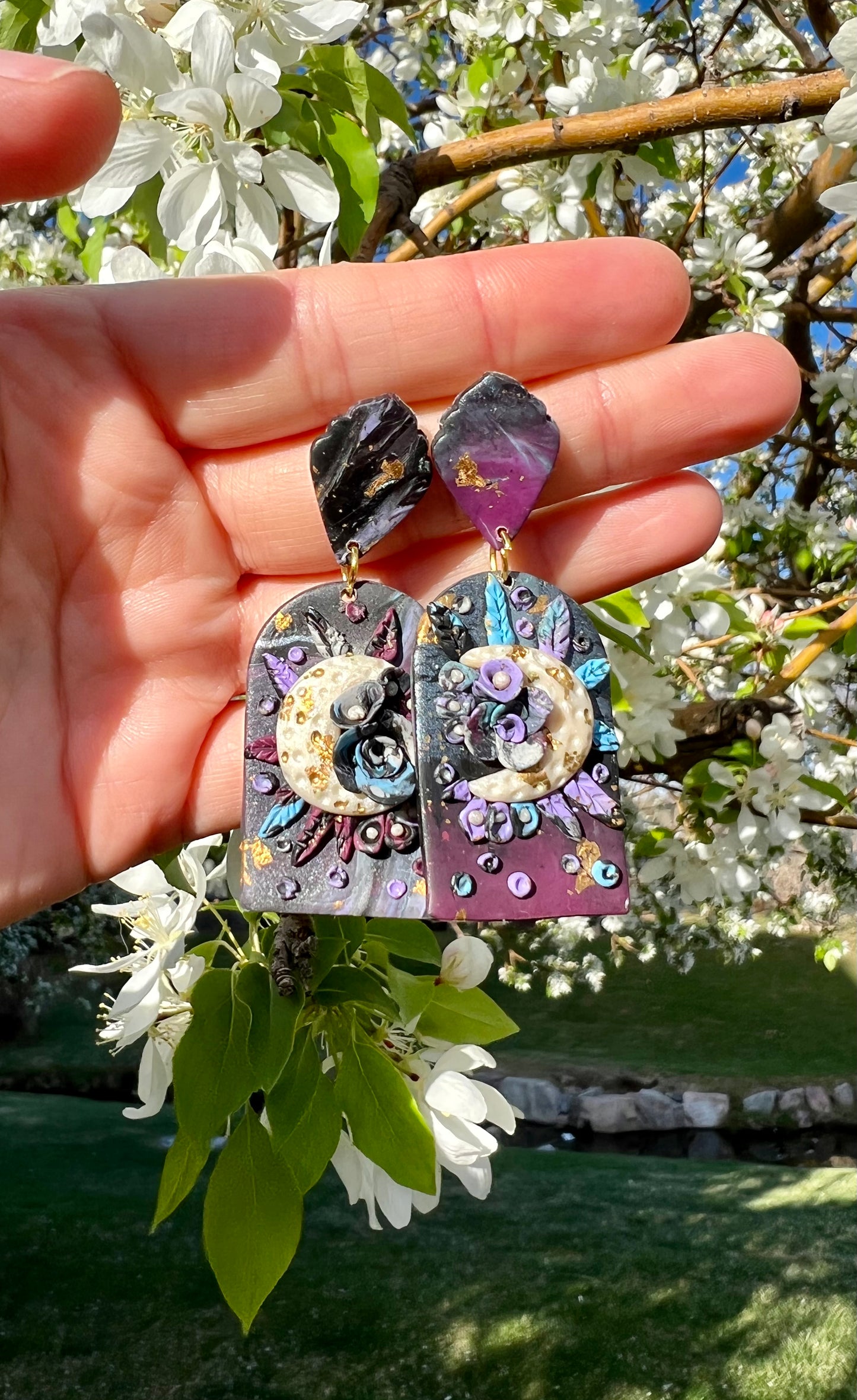 Embrace the beauty of May's Flower Moon with these unique earrings. Handcrafted with love, they capture the essence of wildflowers such as wild garlic, bluebells, and violets. Made from kato polymer clay, these earrings offer both elegance and hypoallergenic wear