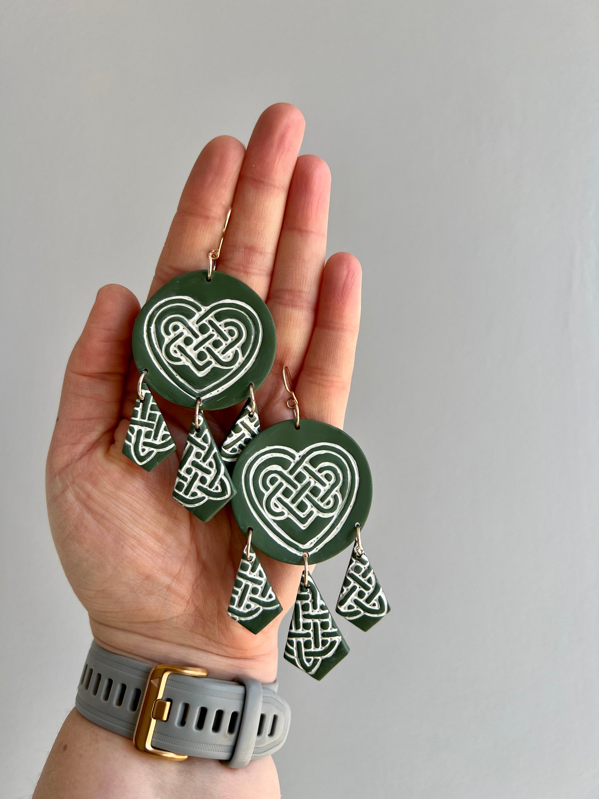 Enhance your style with our stunning green Celtic love knot polymer clay earrings. These intricately crafted accessories embody the timeless symbolism of eternal love and unity. Complete your look with these elegant statement pieces, perfect for any occasion.