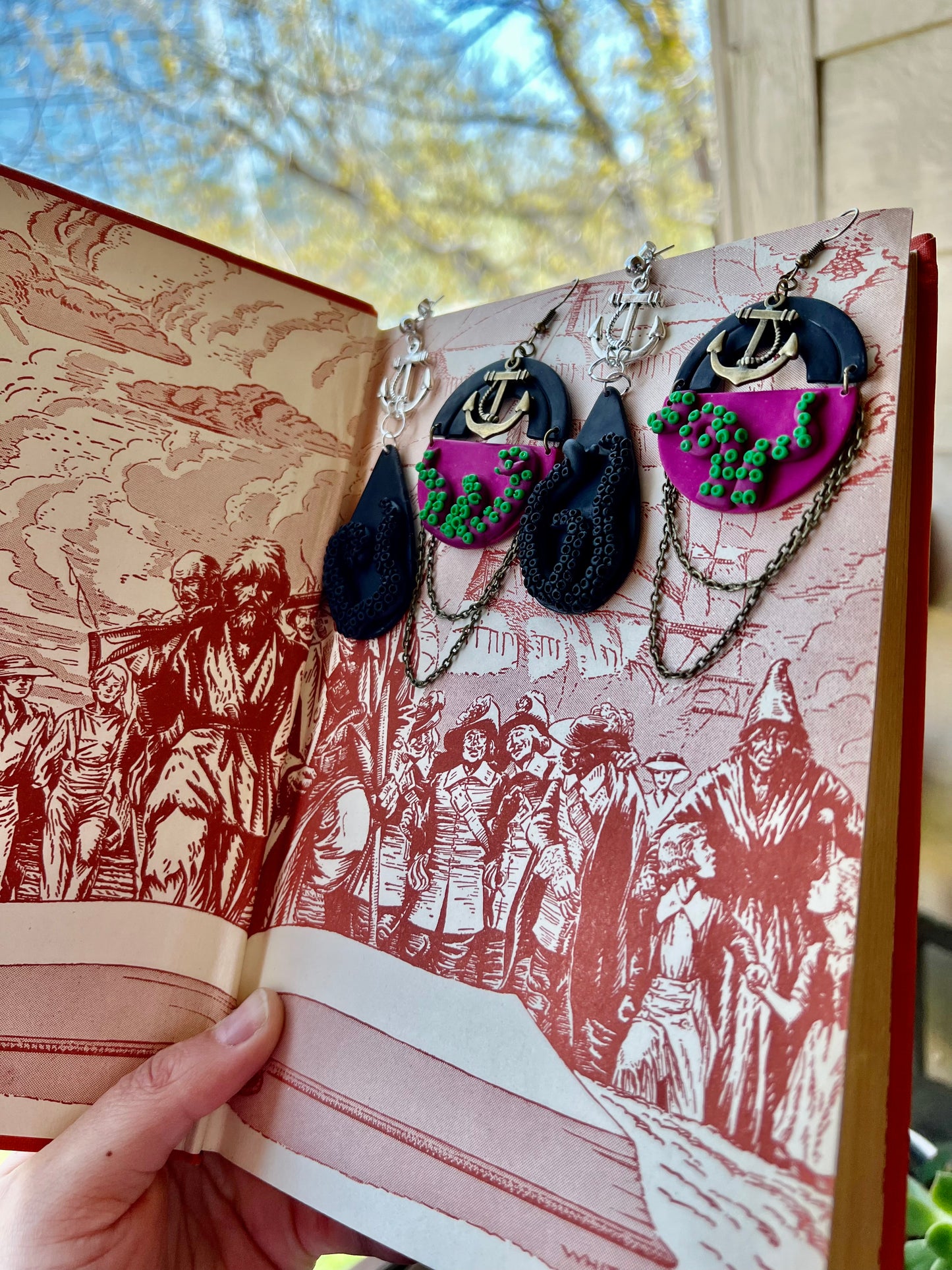 Capture the enchantment of the deep sea with our fuchsia tentacle kraken earrings, adorned with striking green suckers. Let these statement pieces transport you to a world of maritime fantasy and intrigue!