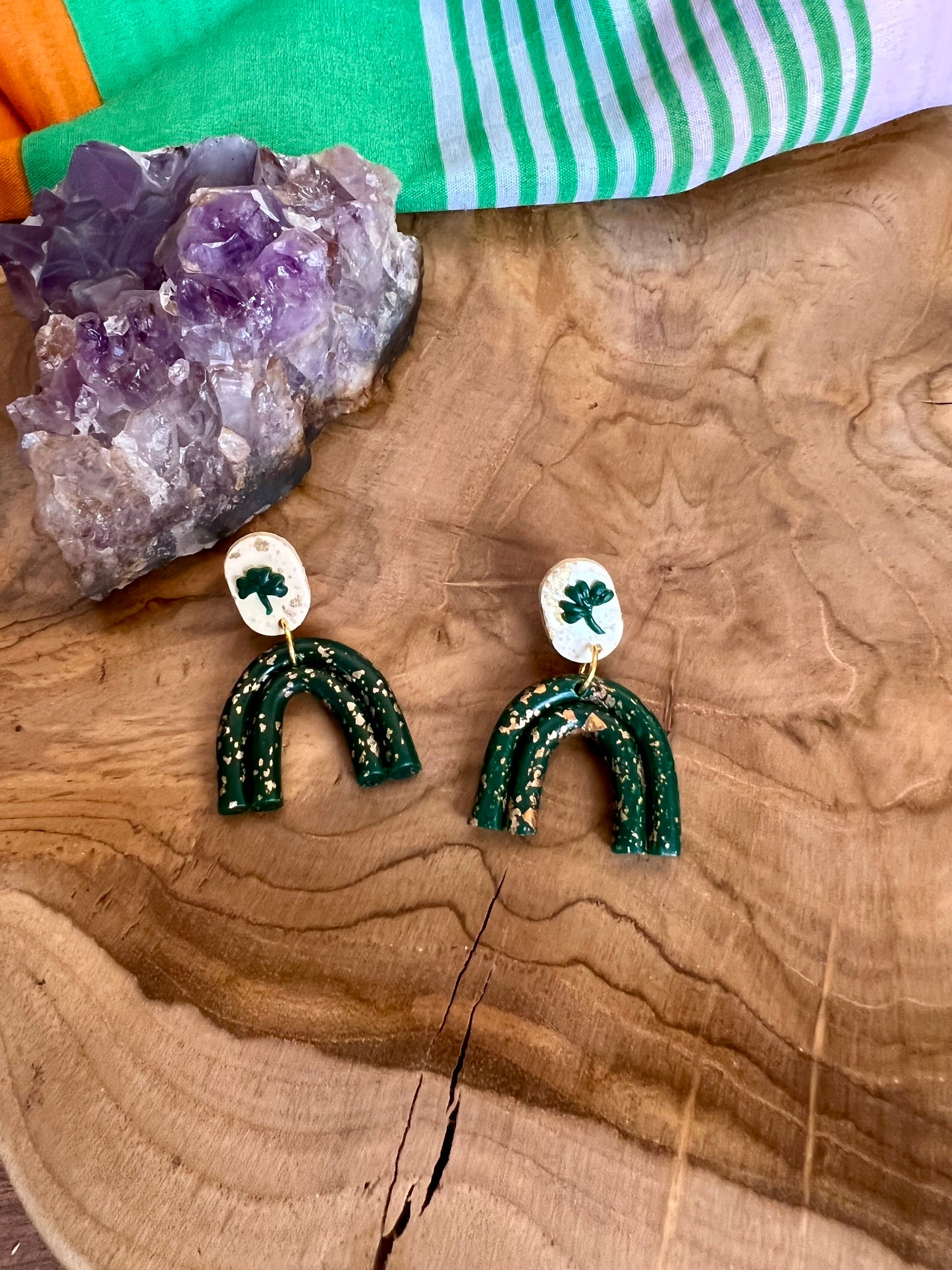 Step into St. Patrick's day with these handmade polymer clay earrings. These rainbow and shamrock earrings are accented by gold leaf. 